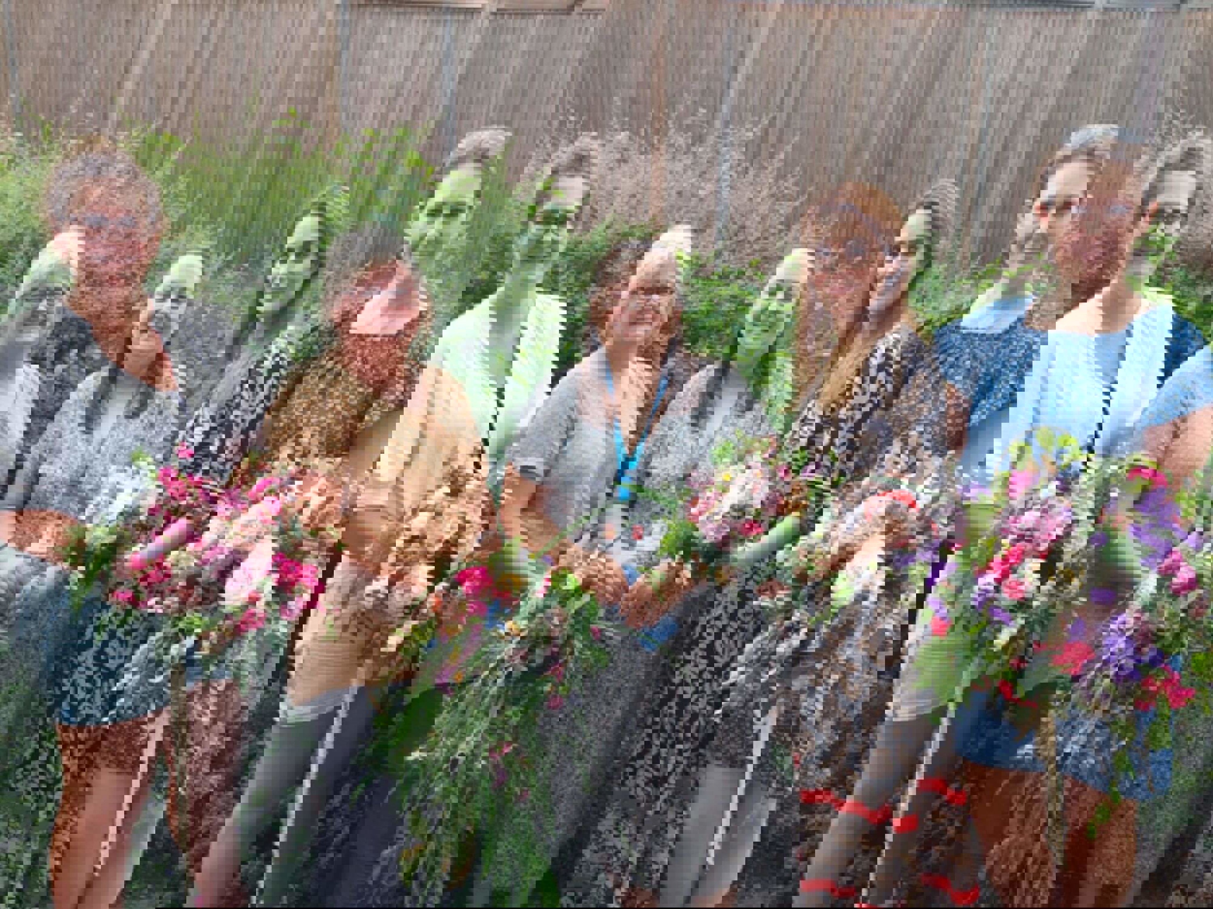 Tutor and students holding flowers