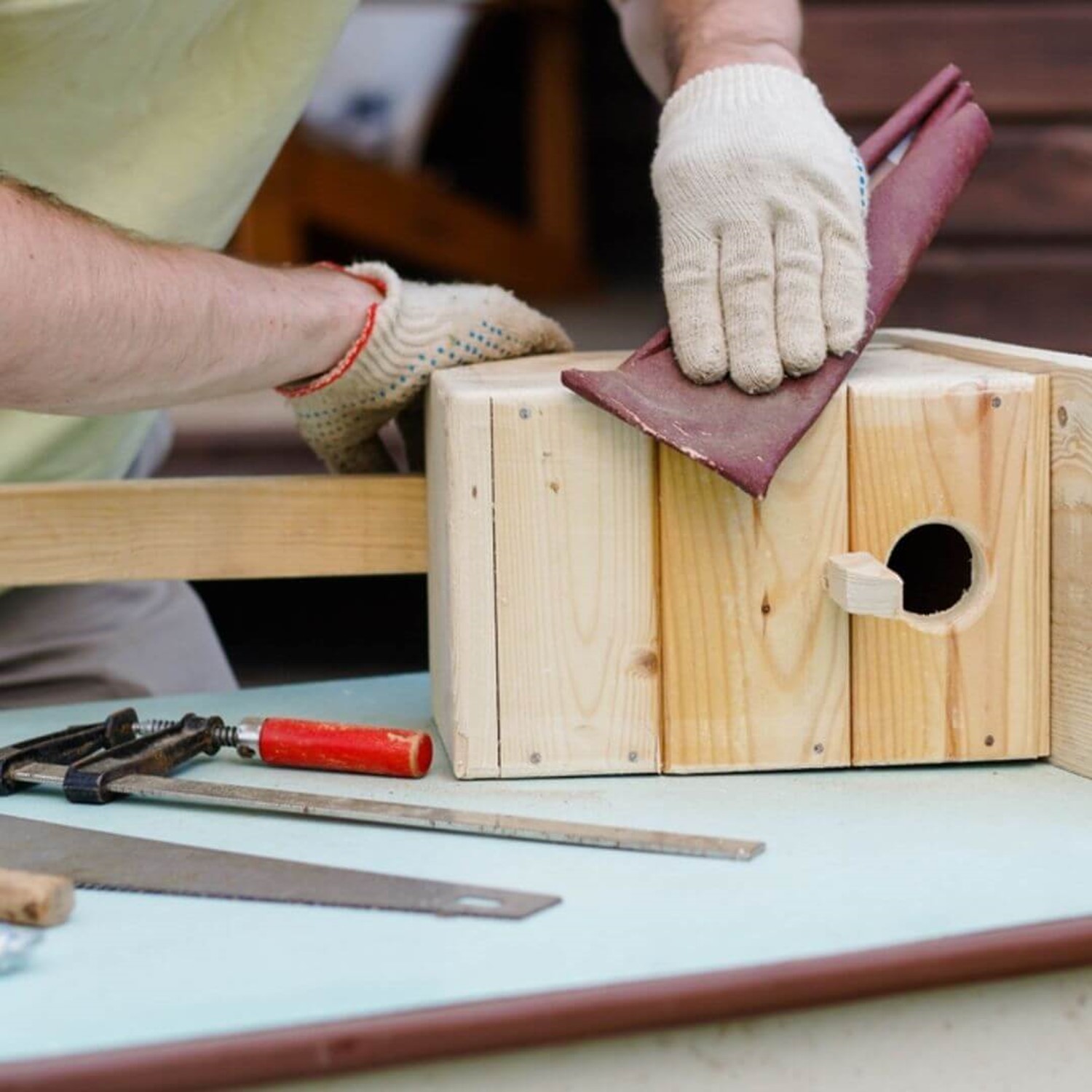 Person making a wooden bird box