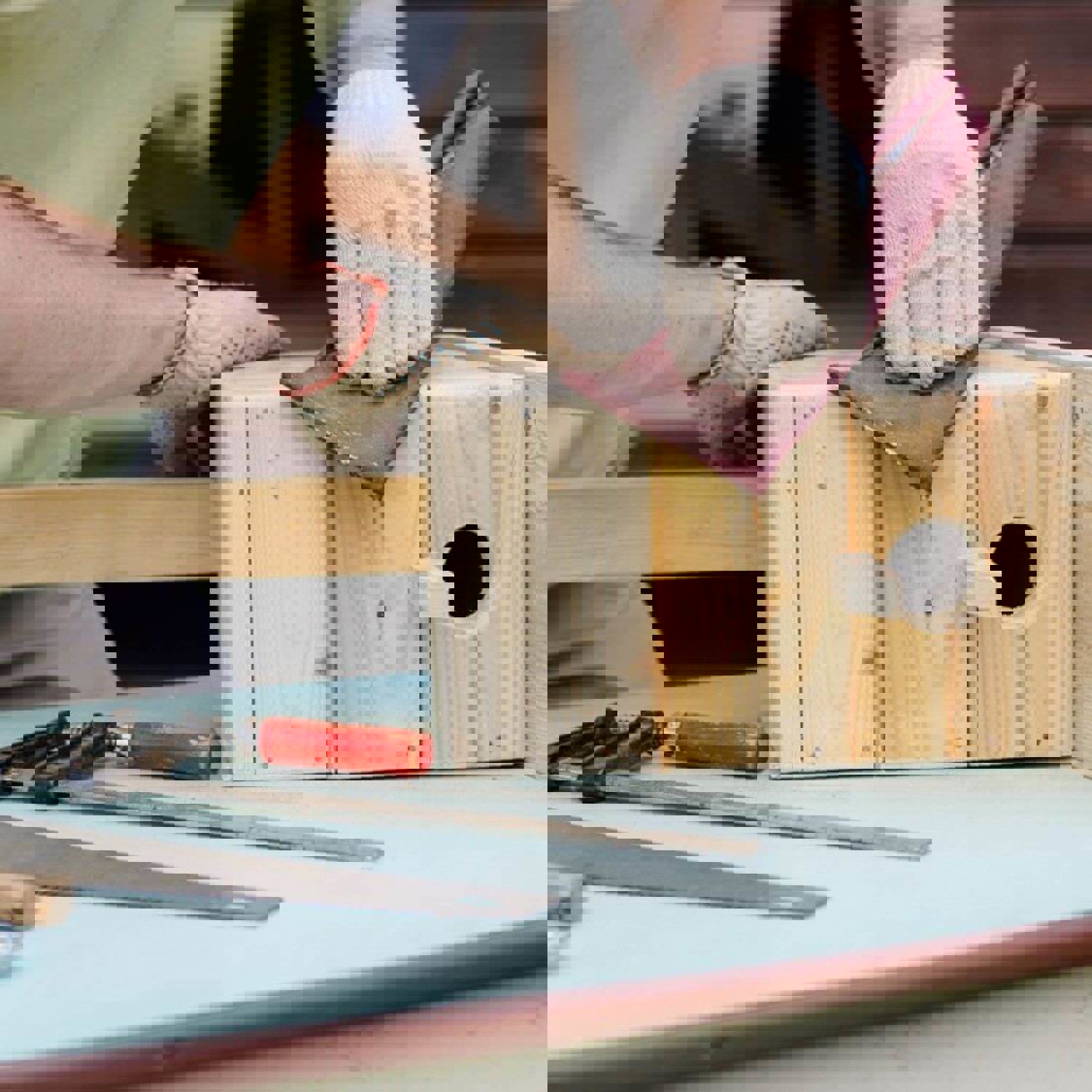 Person making a wooden bird box