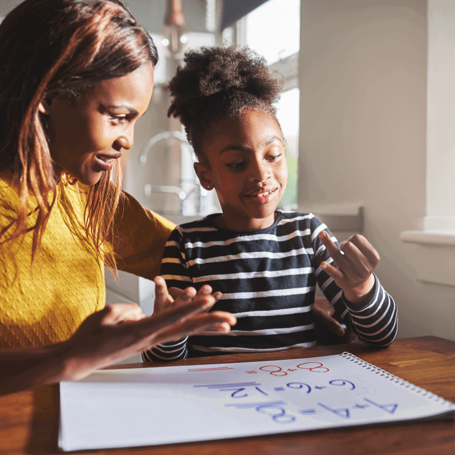 Woman doing sums with girl
