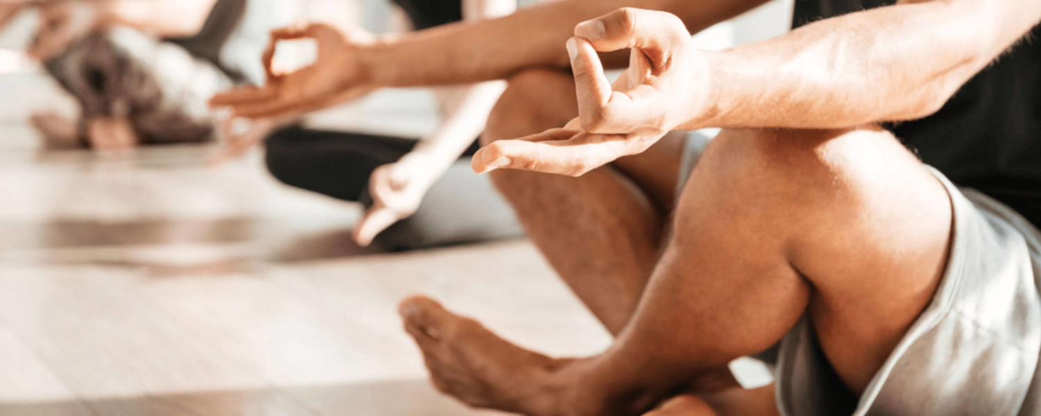 Close up of hands and feet in meditation pose