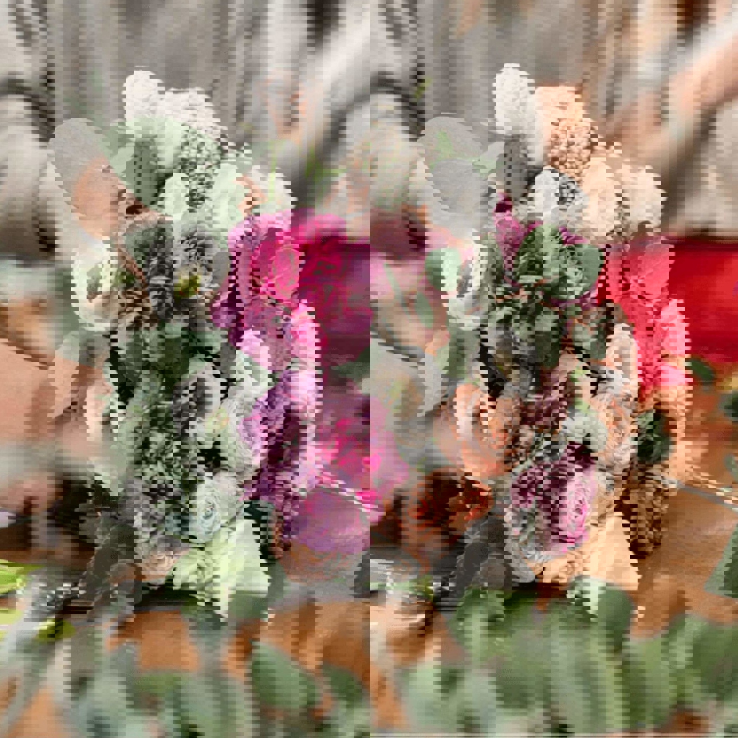 Person tying flowers together