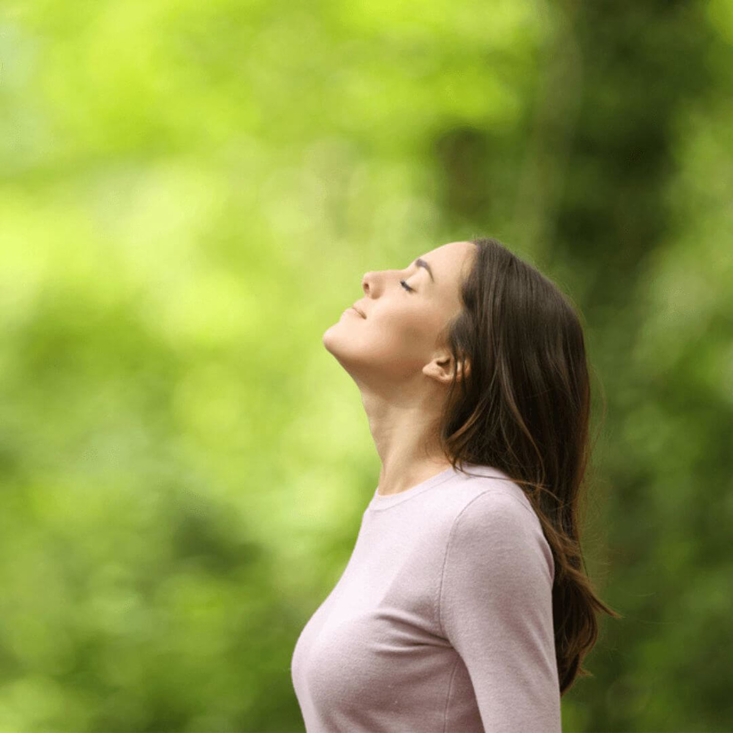 Lady breathing in air by trees