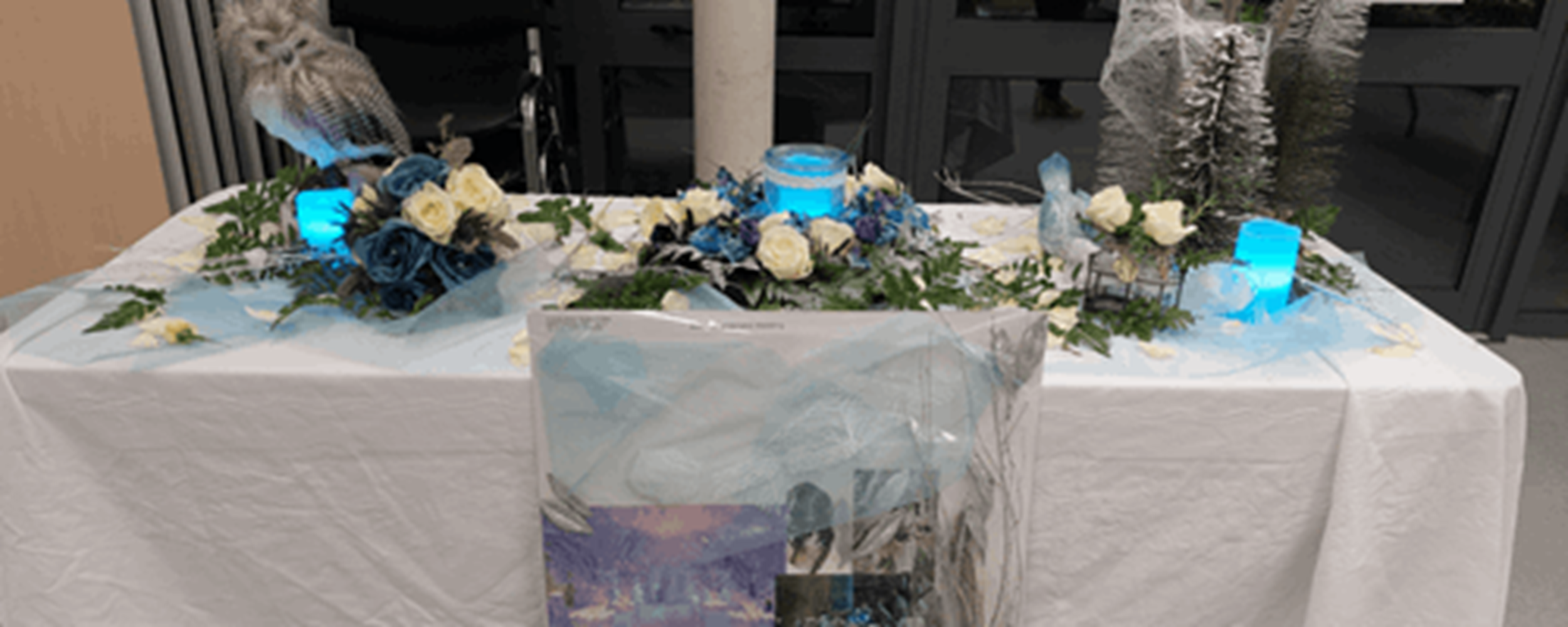Winter flowers around blue candles