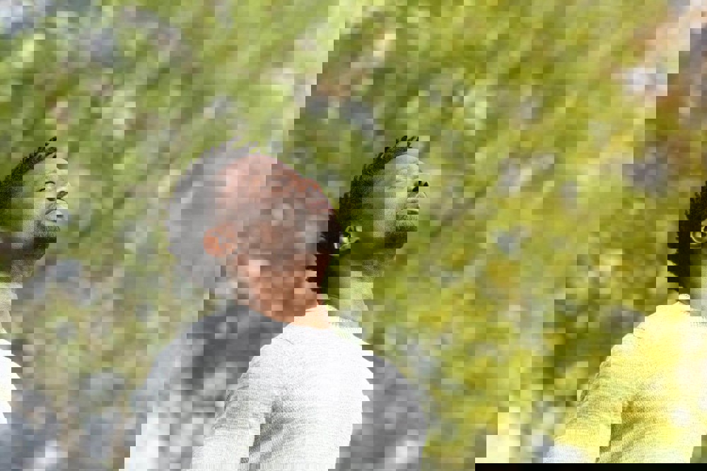 Man looking up to sky with eyes closed