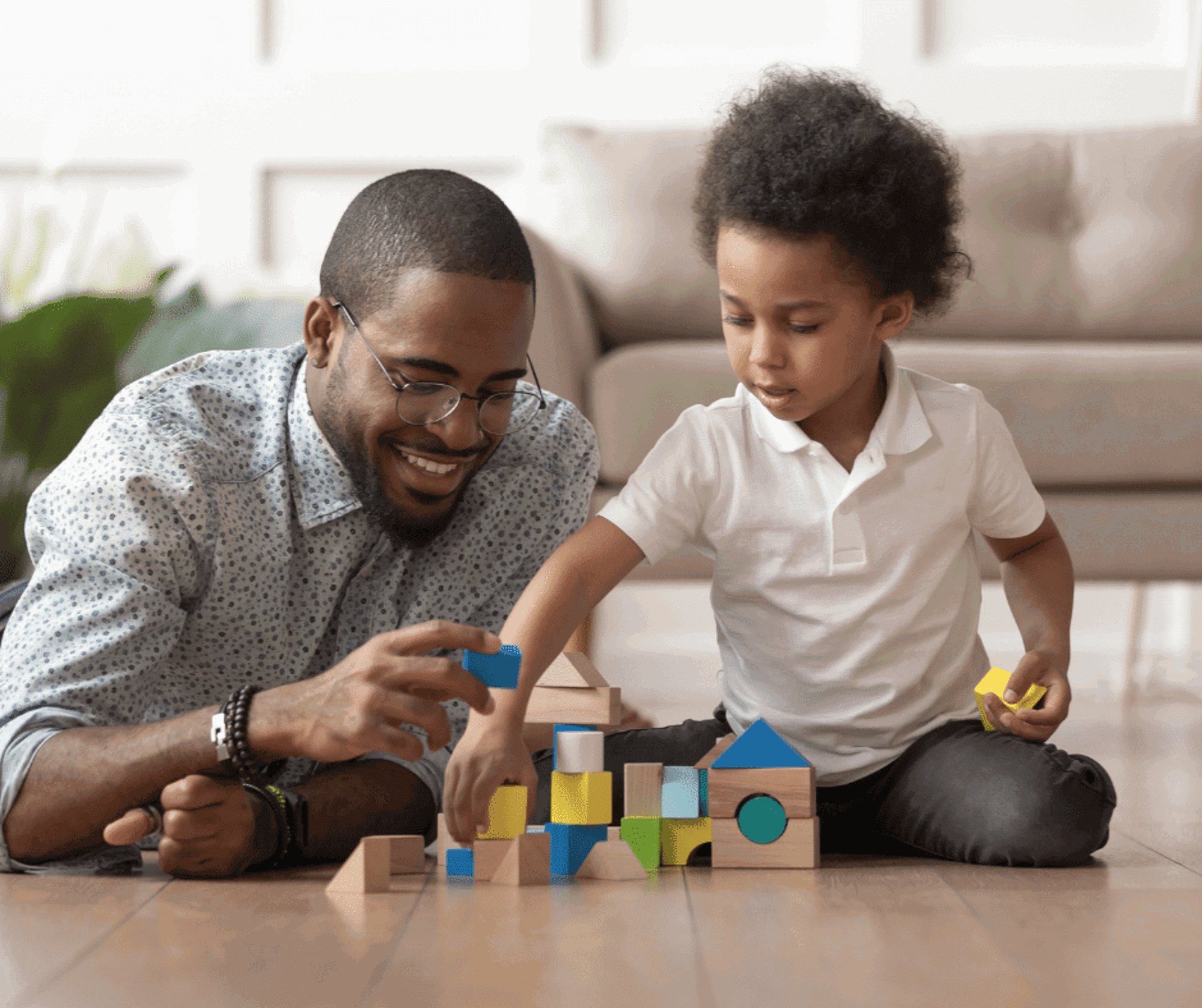 Father and son playing with toy blocks