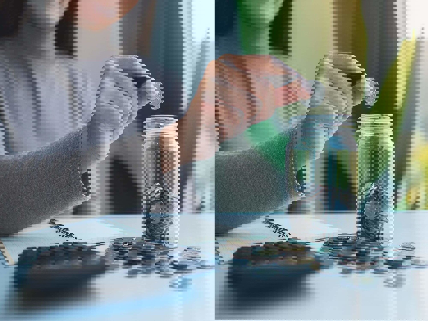 Girl counting coins in jar