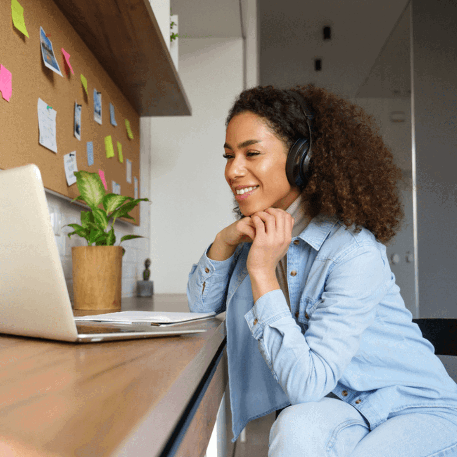 Lady smiling on laptop with headset