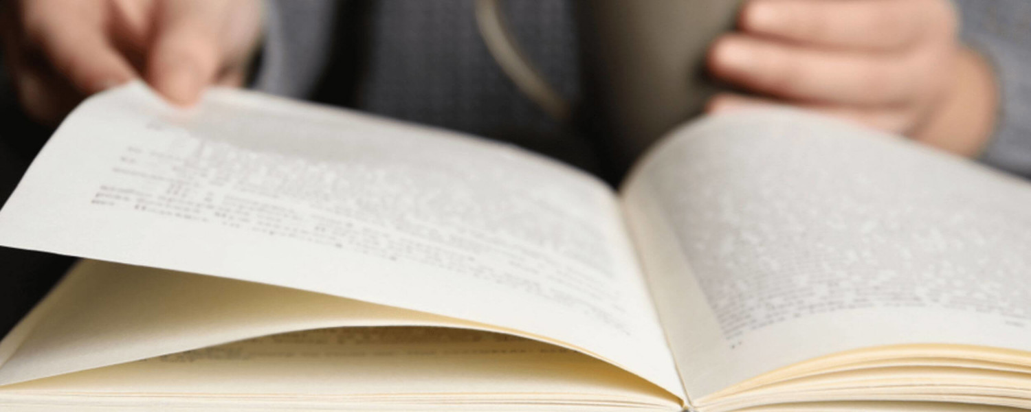 Close up of person reading book