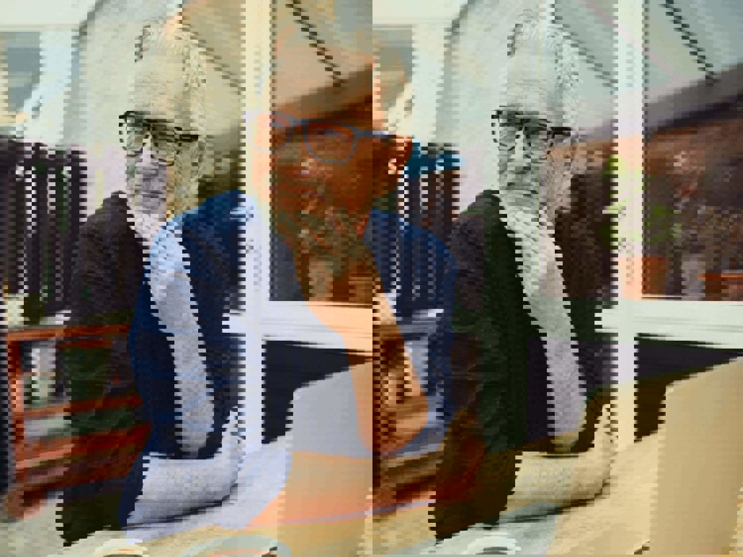 Man smiling on laptop outside