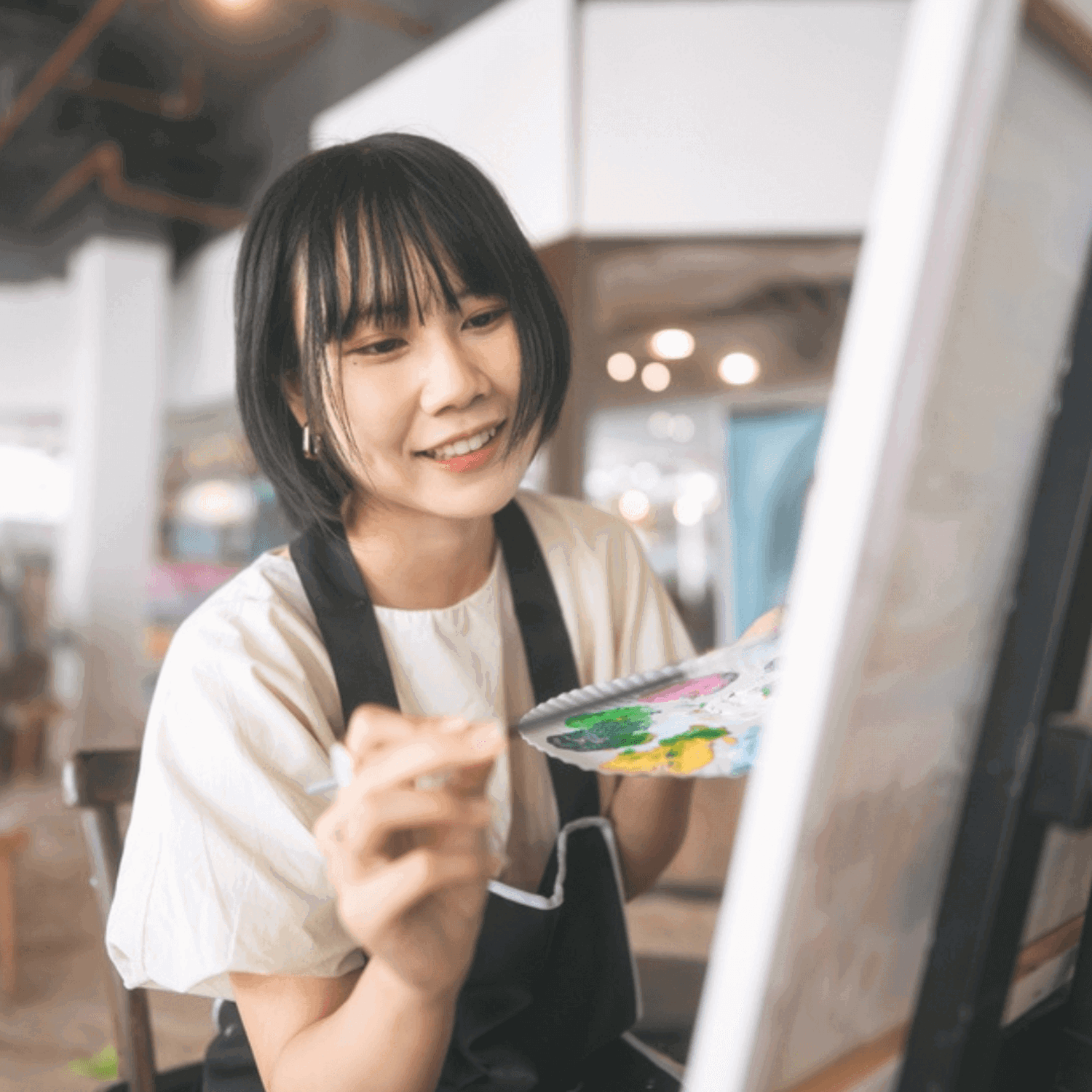 Person painting at an easel