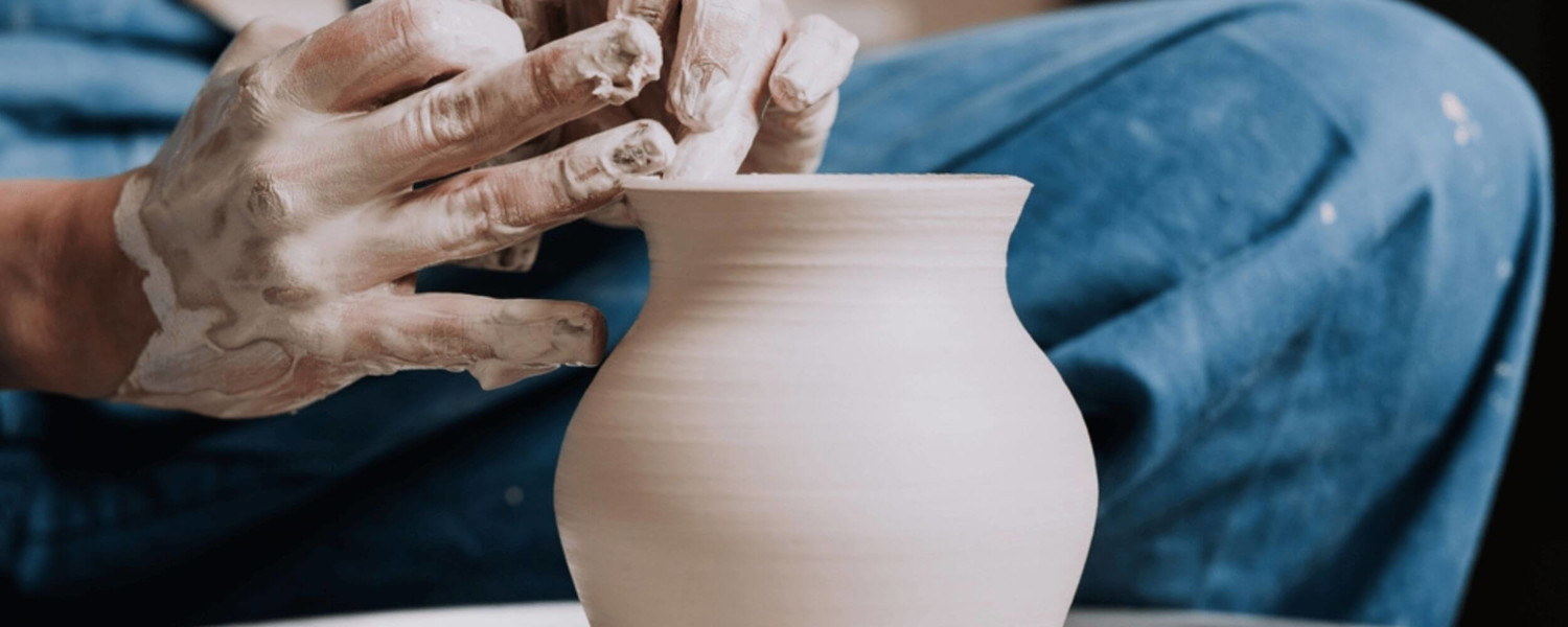 Close up of hands making clay vase