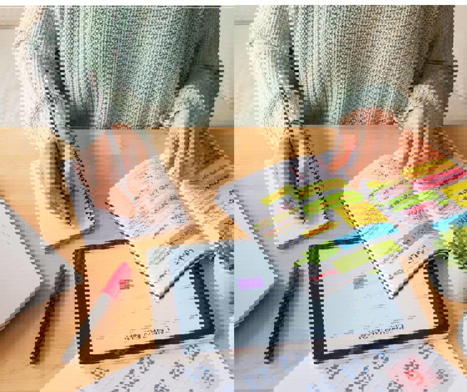 Person writing in a calendar and planner