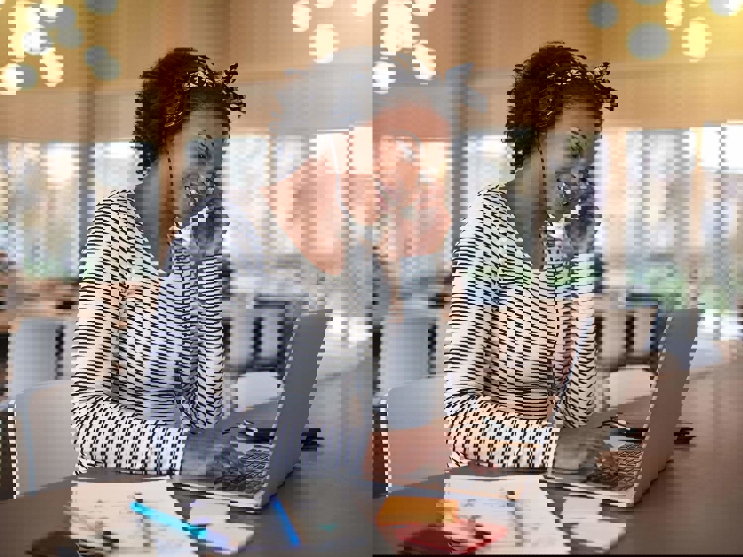 Woman smiling on laptop