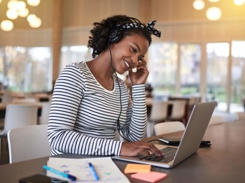 Woman smiling on laptop