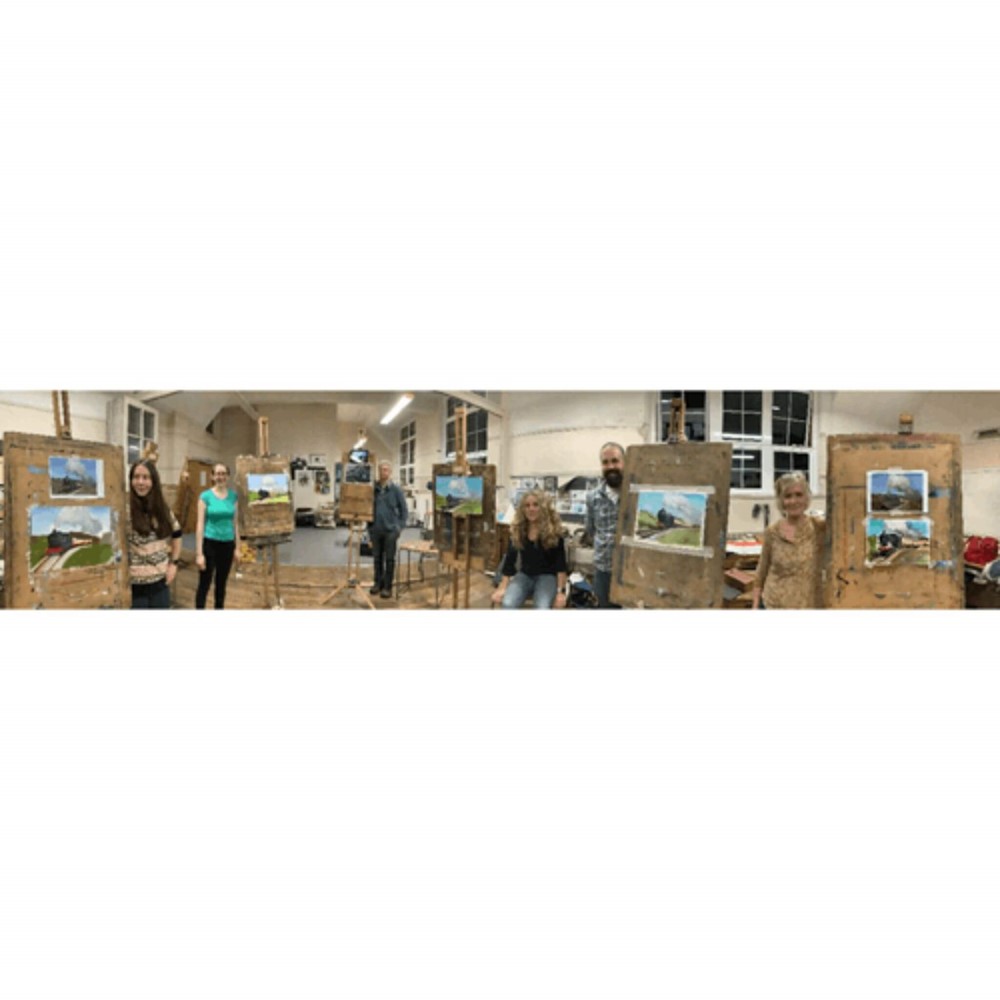 Learners standing next to their paintings