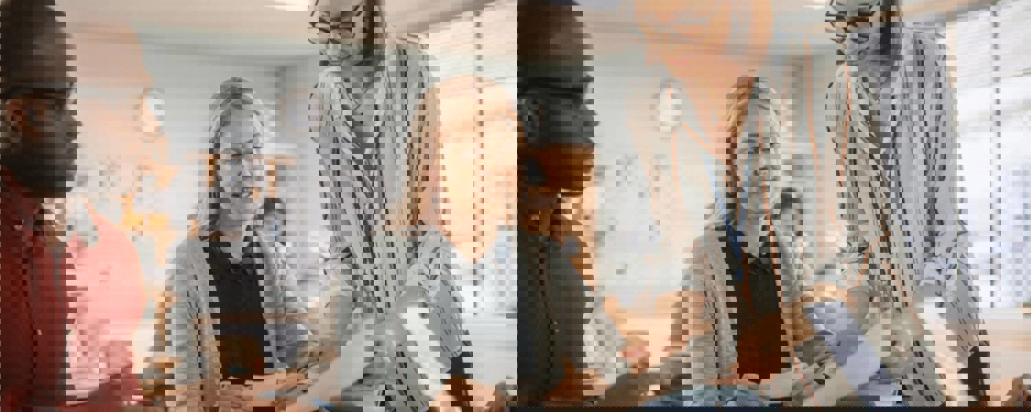 Teacher showing adult learners paper