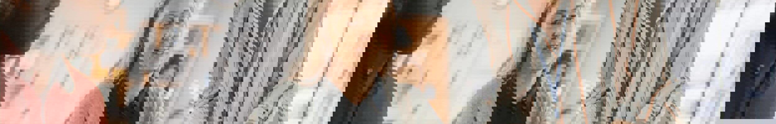 Teacher showing adult learners paper