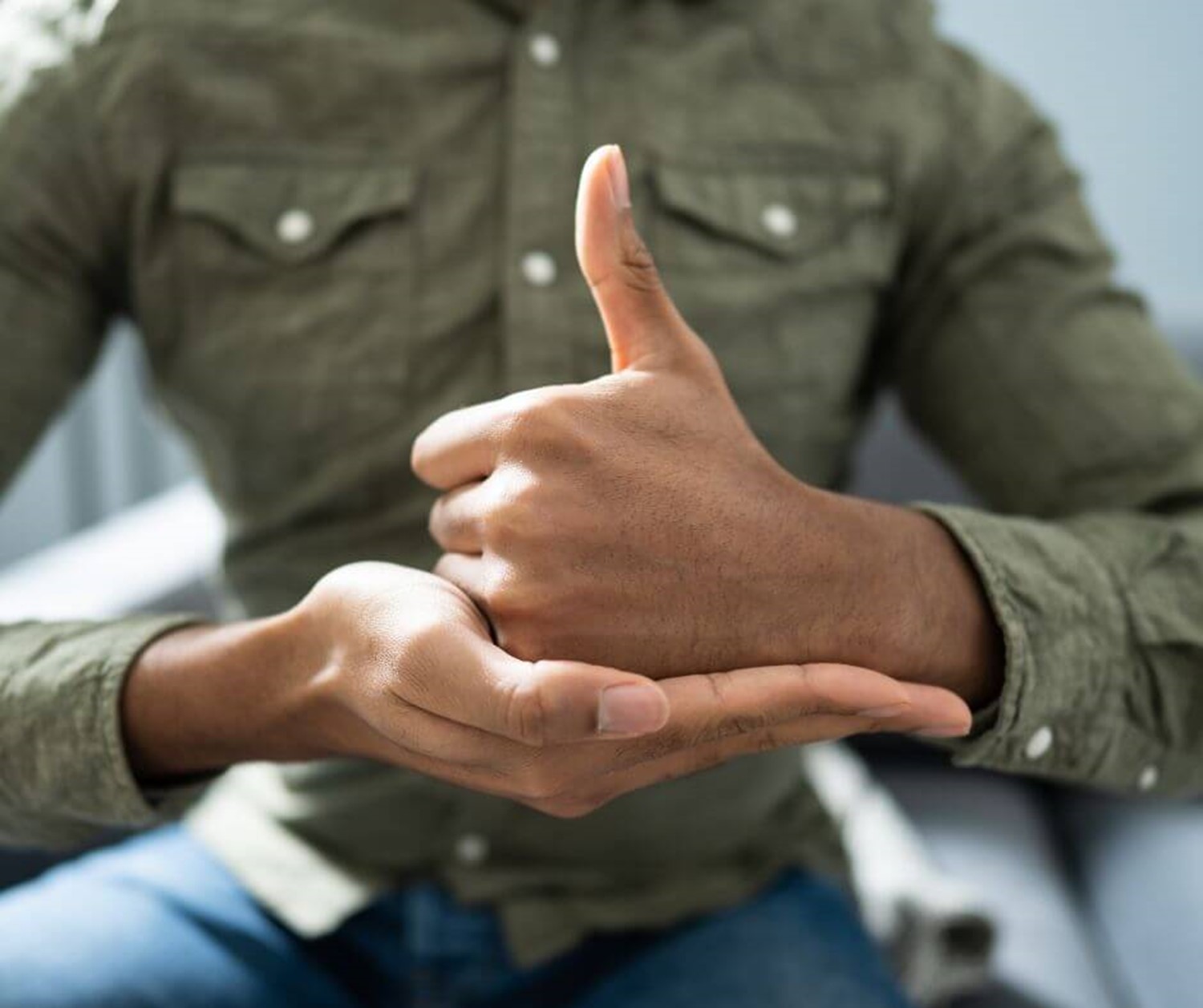 Close up image of persons hands communicating in sign language