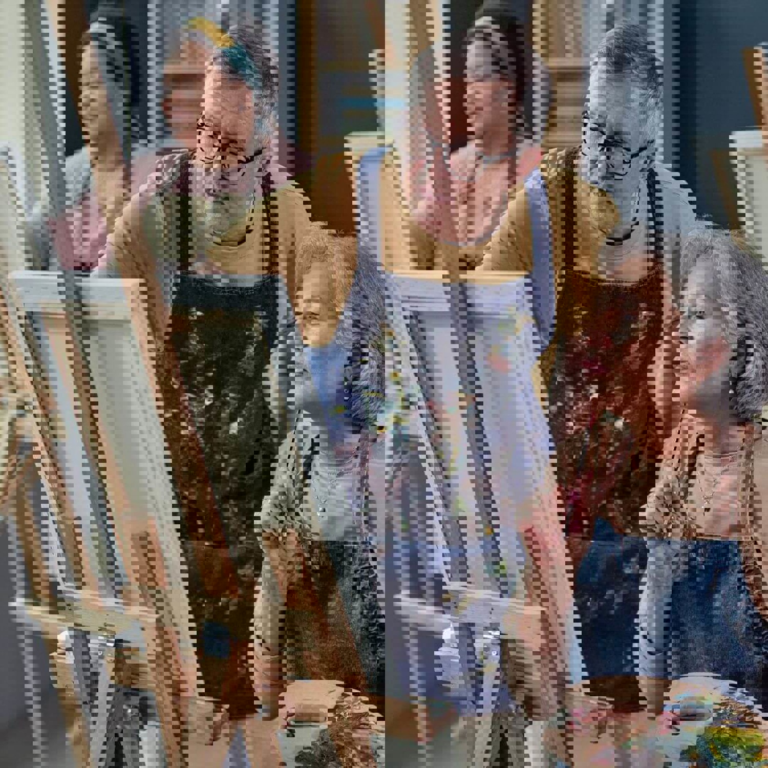 Two people working on an artist easel