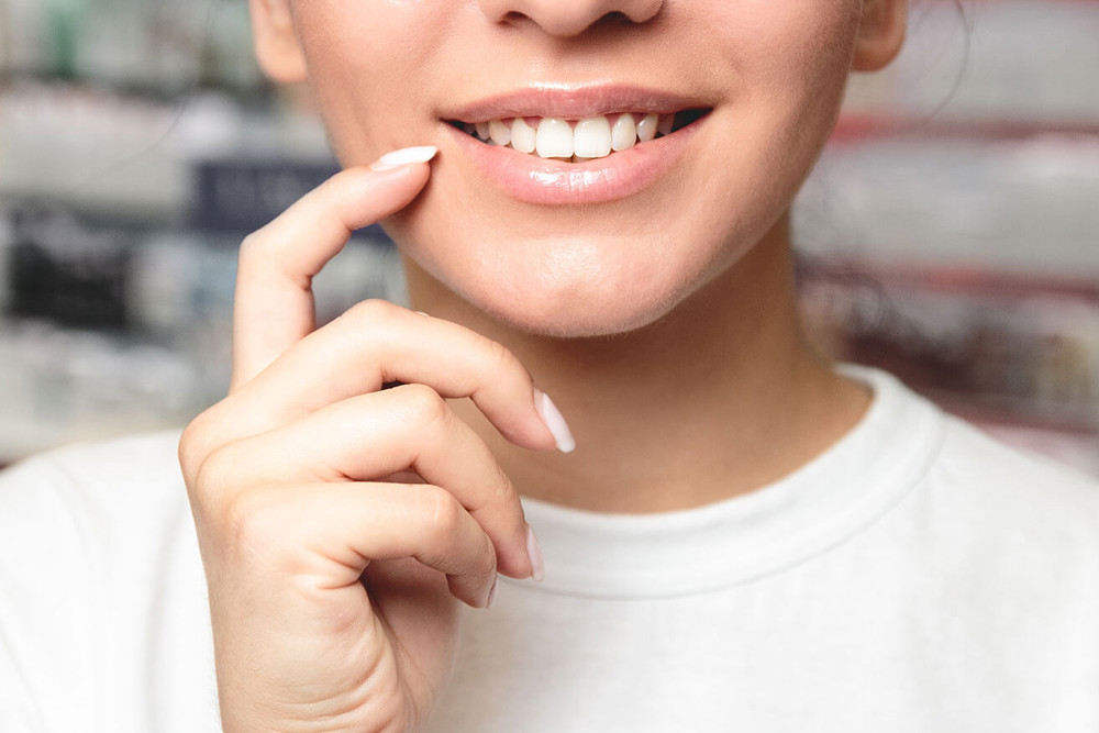 Woman pointing to lips 