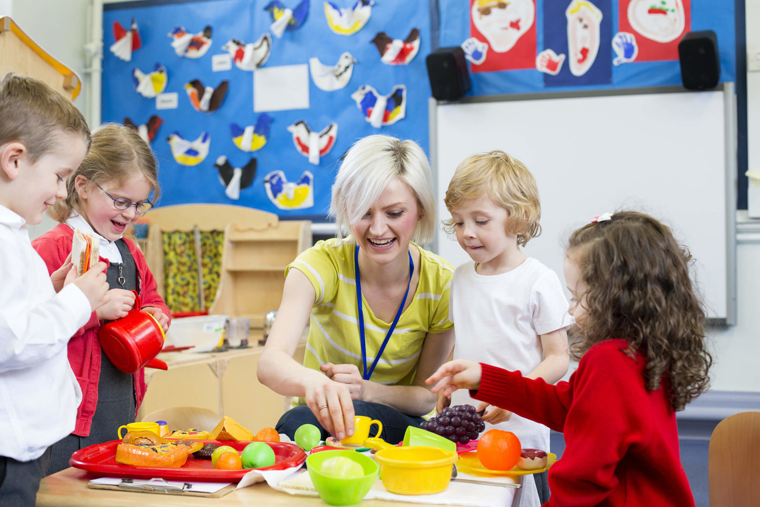 Teacher and young children in classroom
