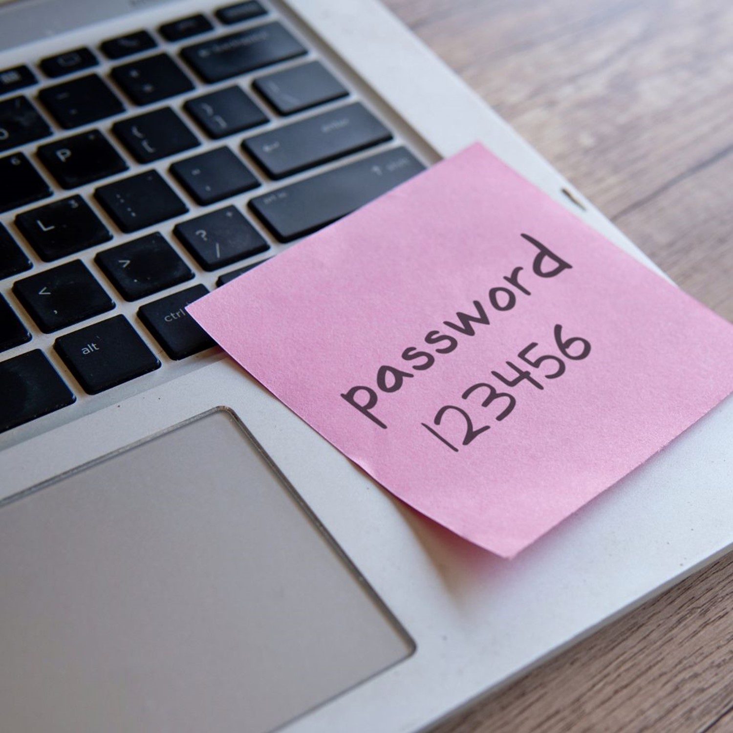 Laptop with a post-it note on saying Password 12345
