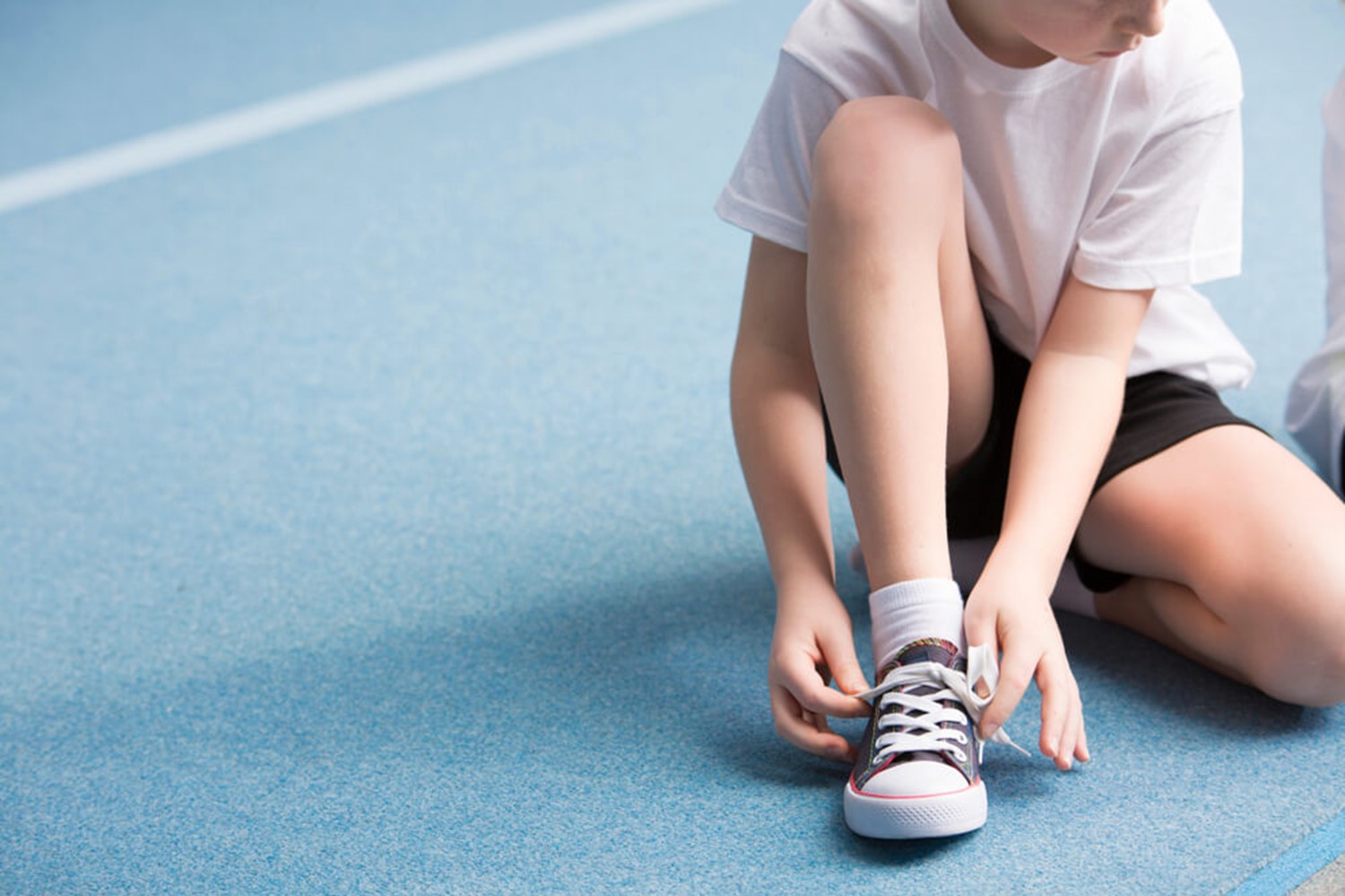 Boy tying shoes