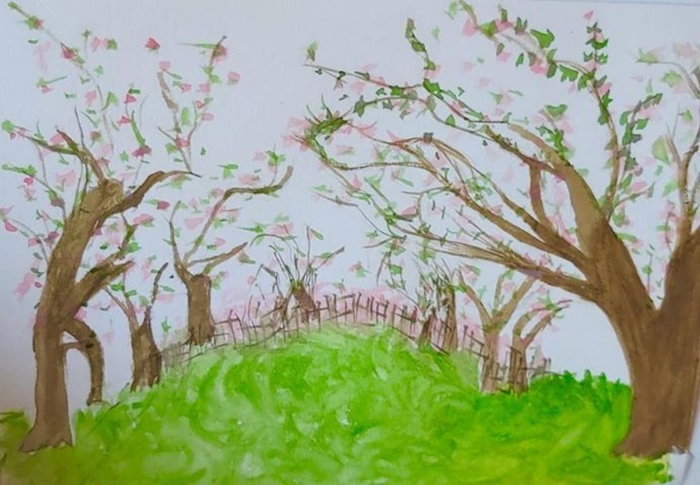 Learner painting of flowering trees in a meadow