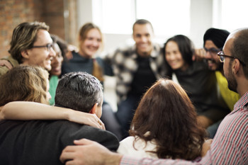 A circle of adults smiling