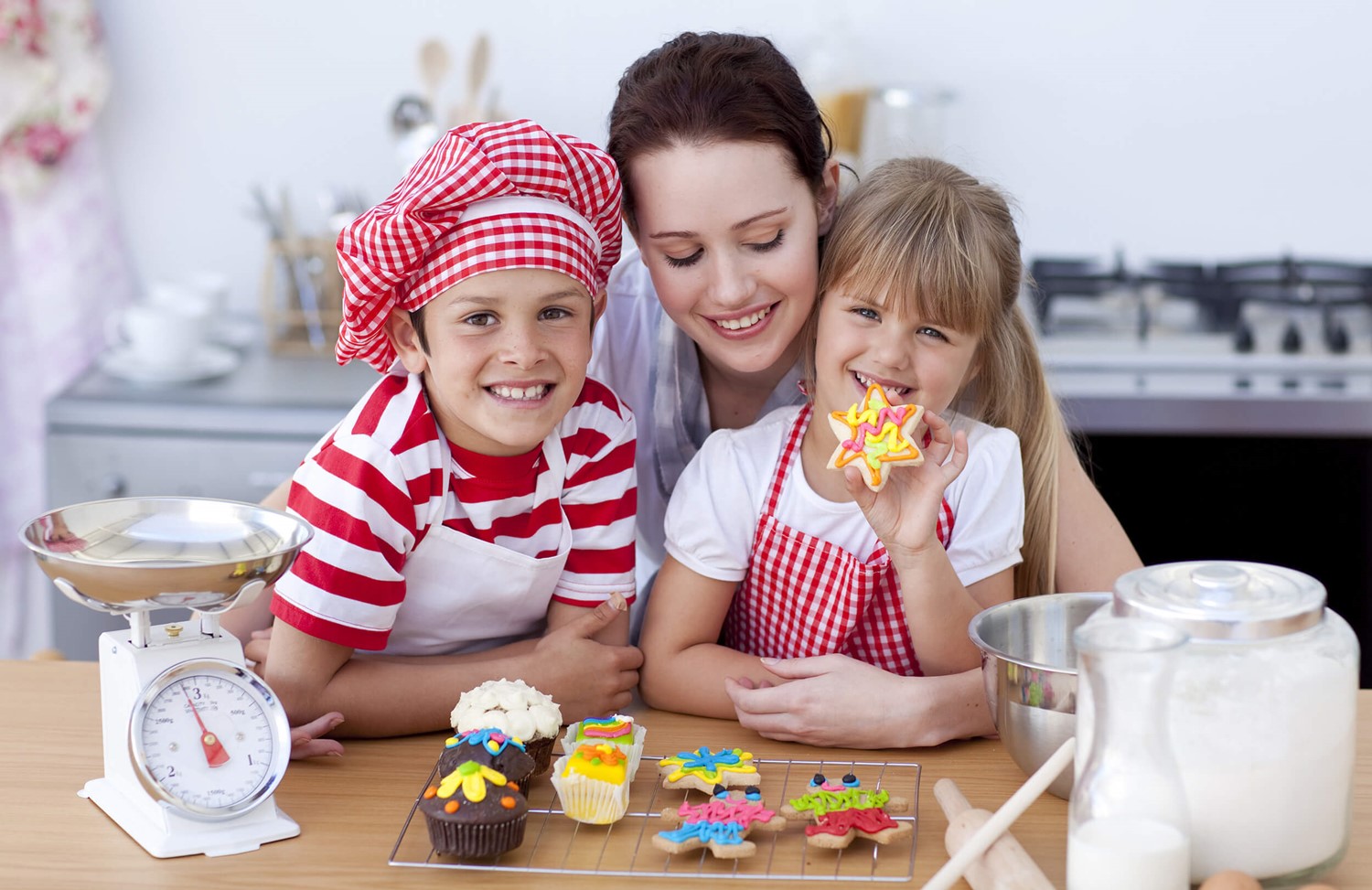 Mother and two children baking