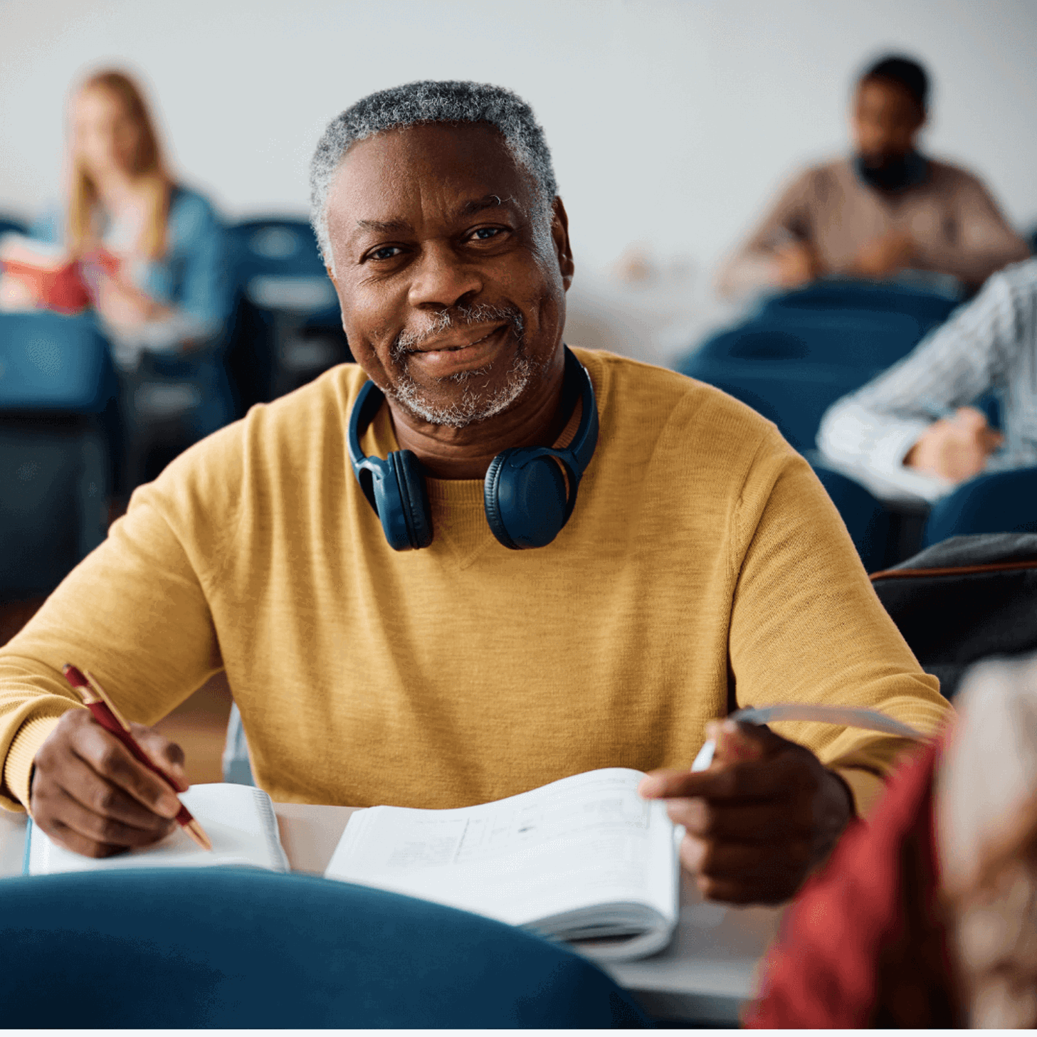 Person sitting in a classroom smiling