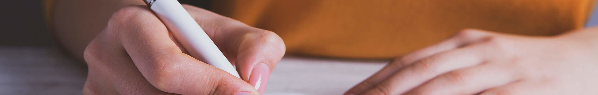 A woman writing notes in a notebook