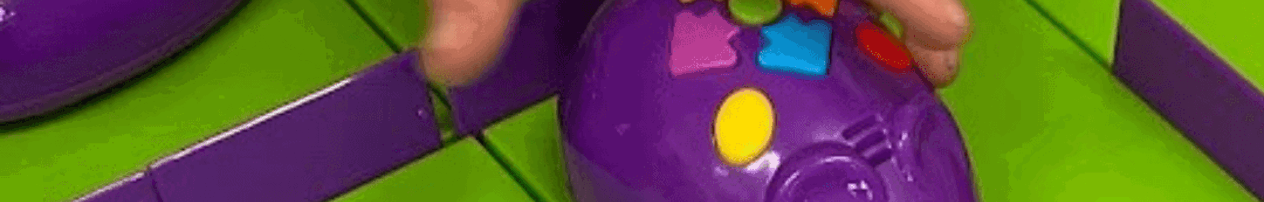 Child's hand on toy mouse with buttons