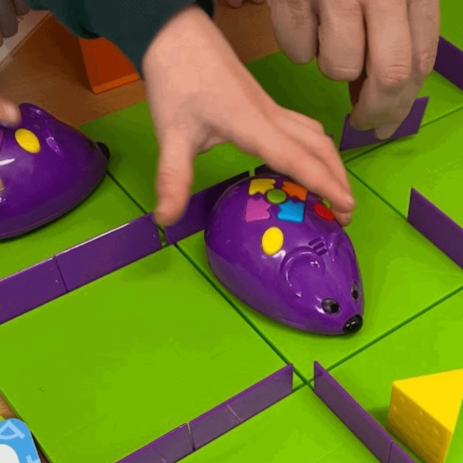 Child's hand on toy mouse with buttons