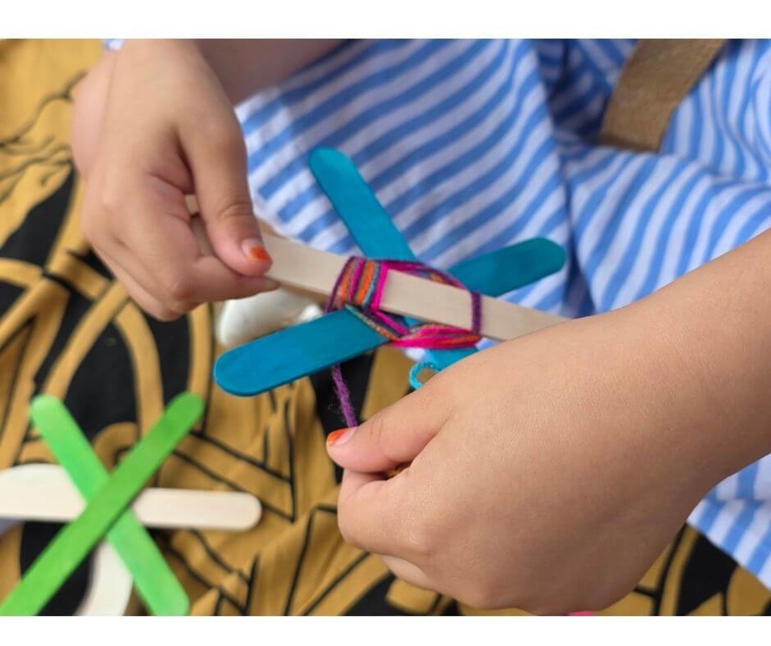 Child making a woven turtle