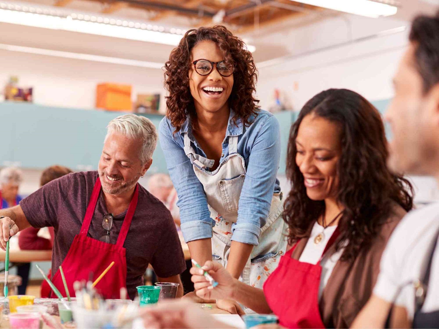 Adults smiling and painting