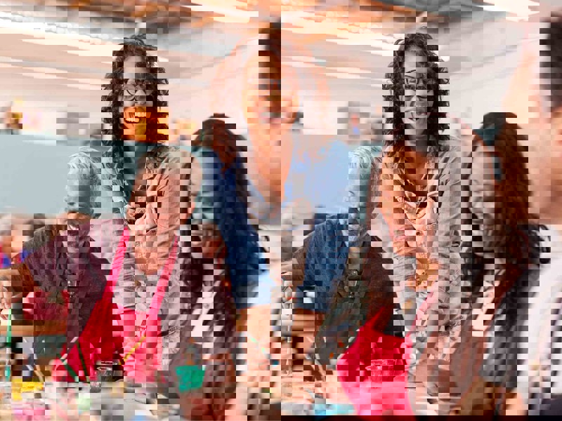 Adults smiling and painting