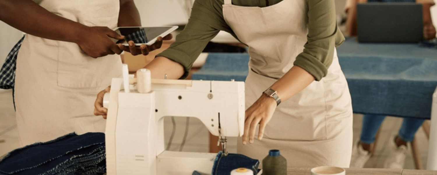 Close up of man and woman at sewing machine