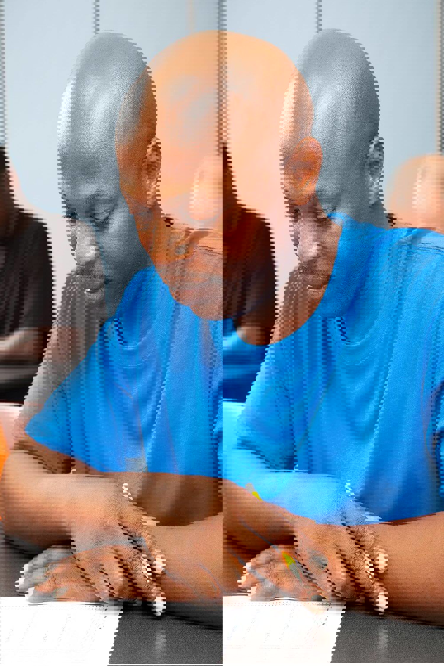 Man looking at a piece of paper on a desk