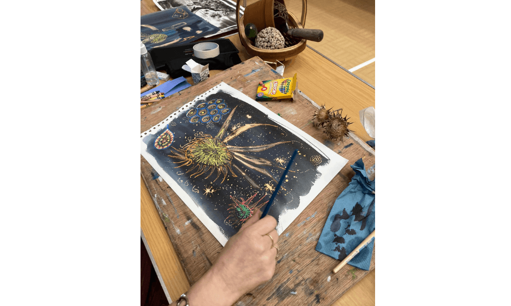 Person painting a plant