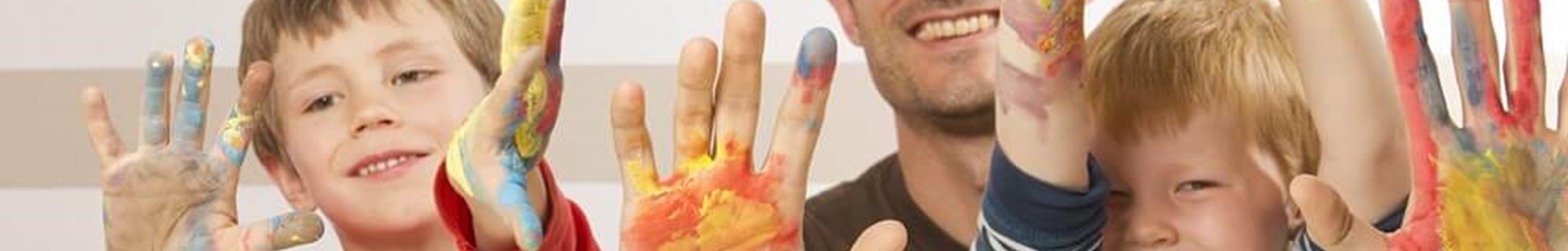 Children and father with paint on hands