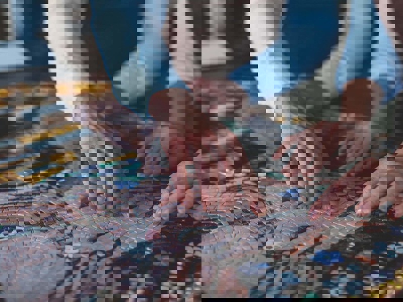 Two people creating a mosaic