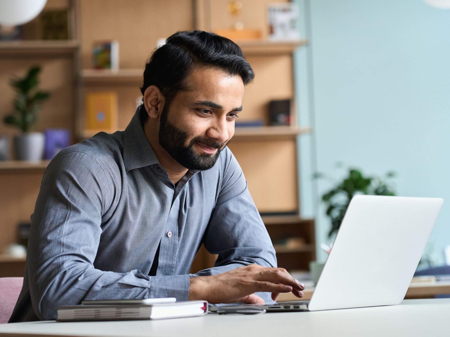 Man smiling at laptop