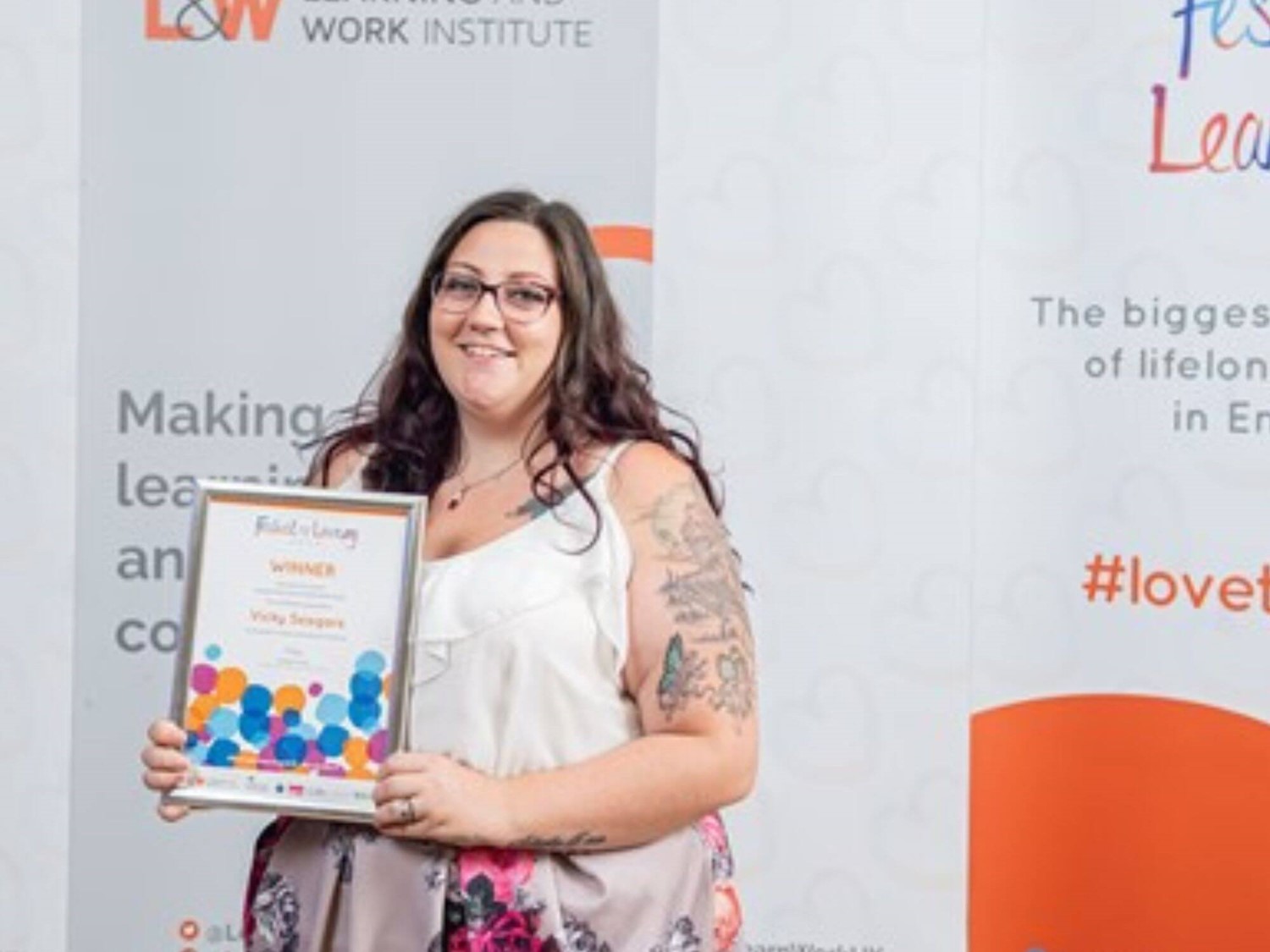 Woman holding up certificate