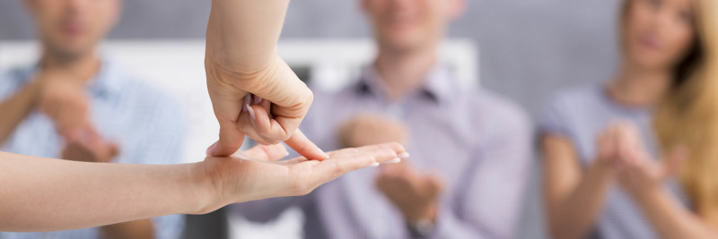 Students using sign language to communicate