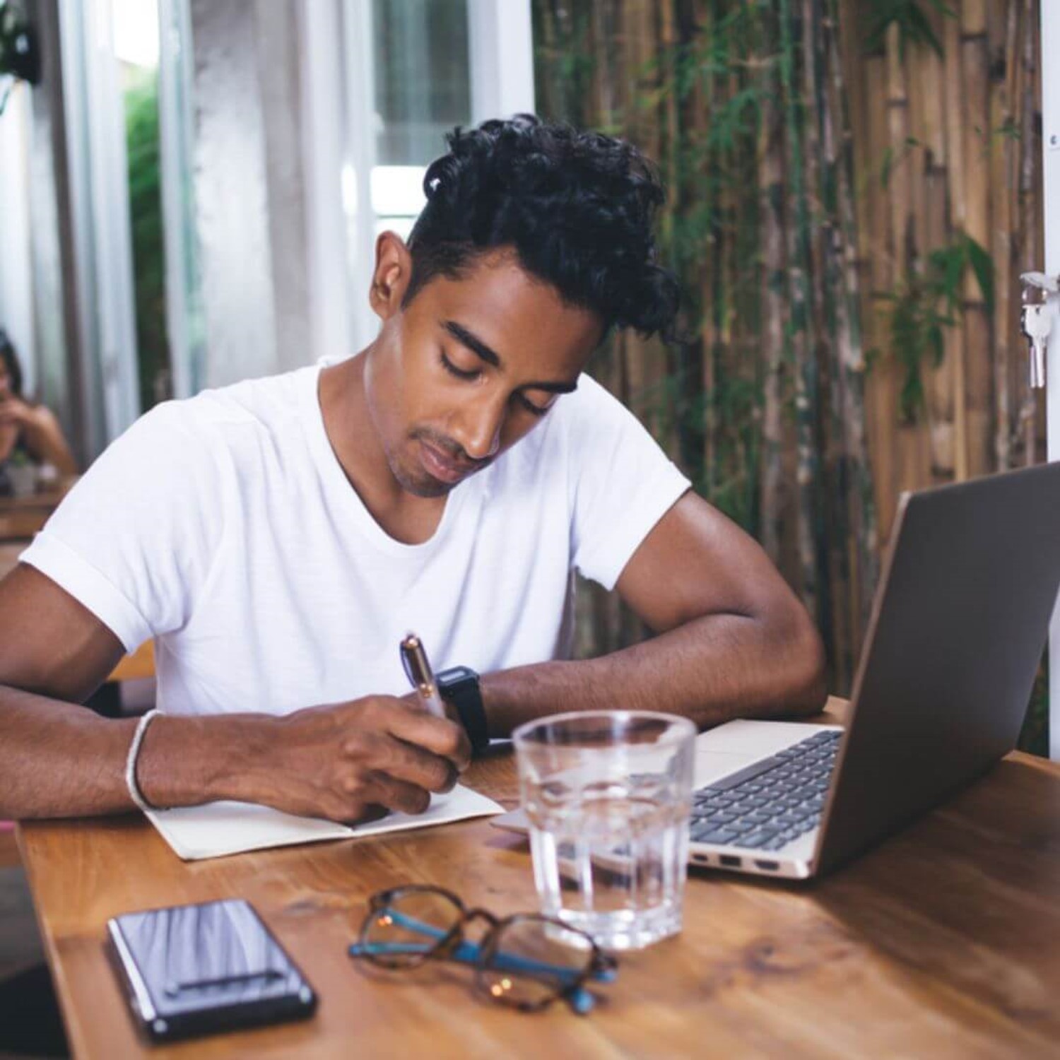 Man writing at laptop