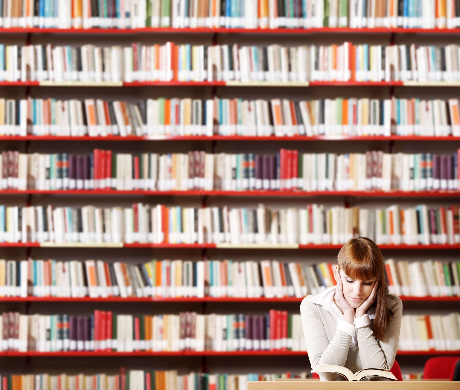 Woman reading a book in a library