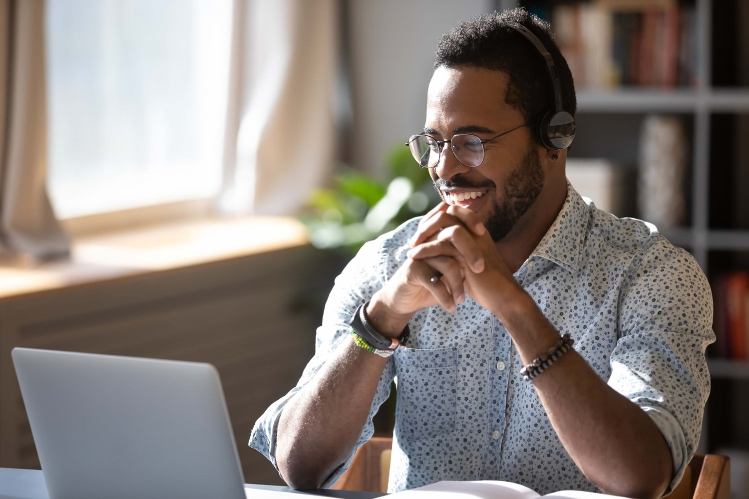 Man smiling at laptop