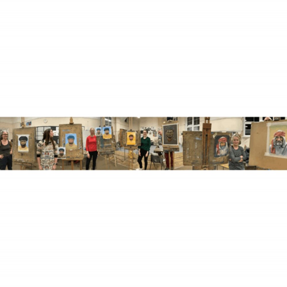 Learners standing next to their paintings